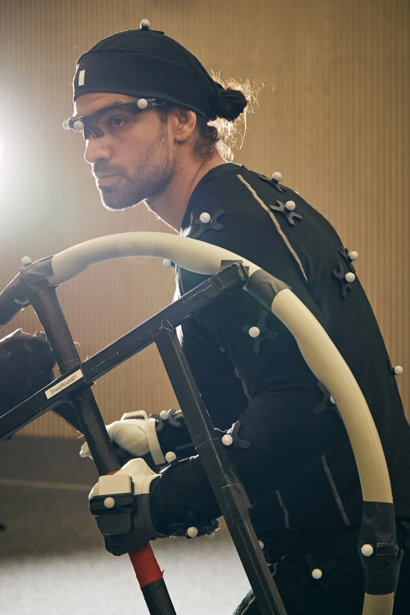 Motion capture performer crouching in studio