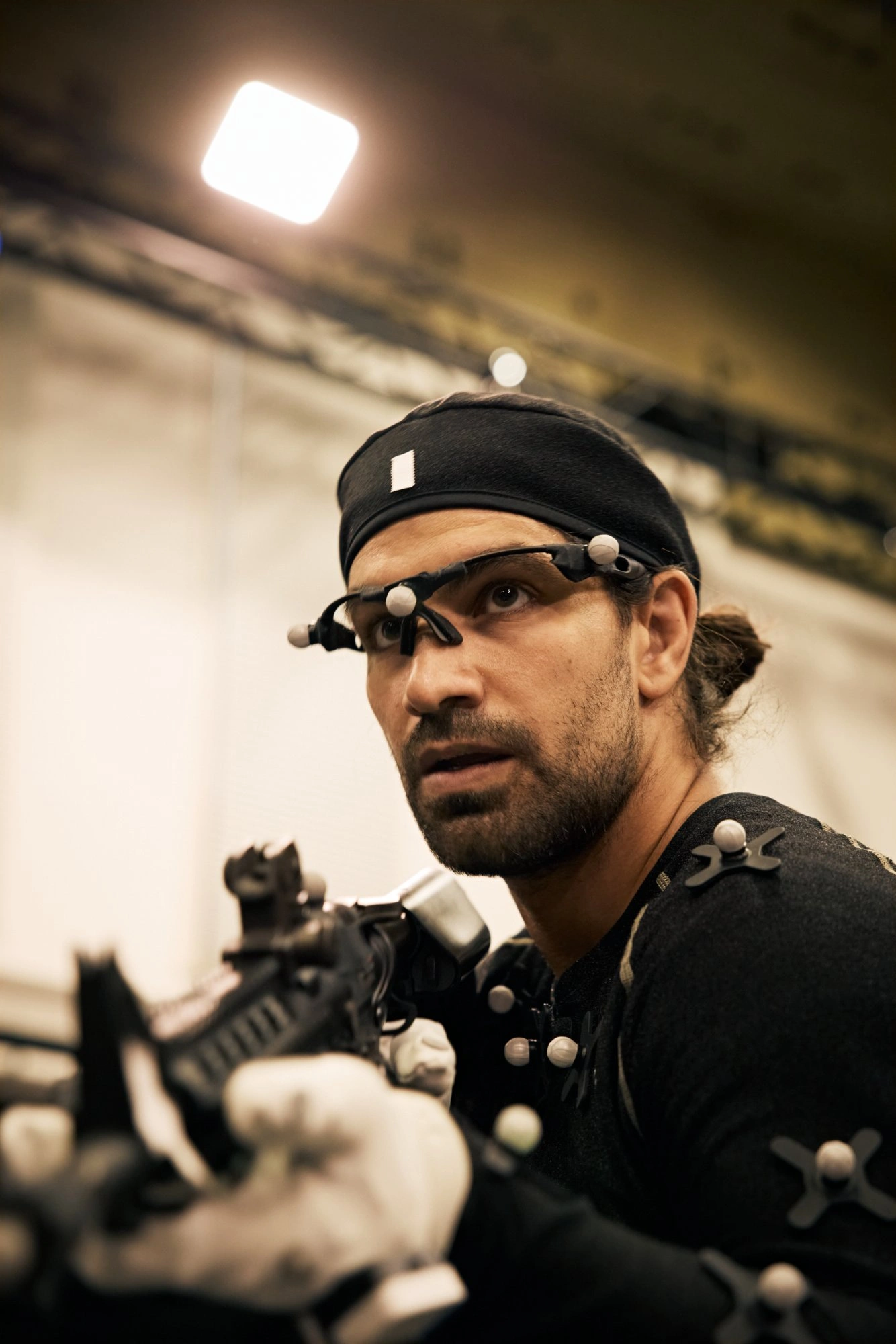 Motion capture performer looking at gloves