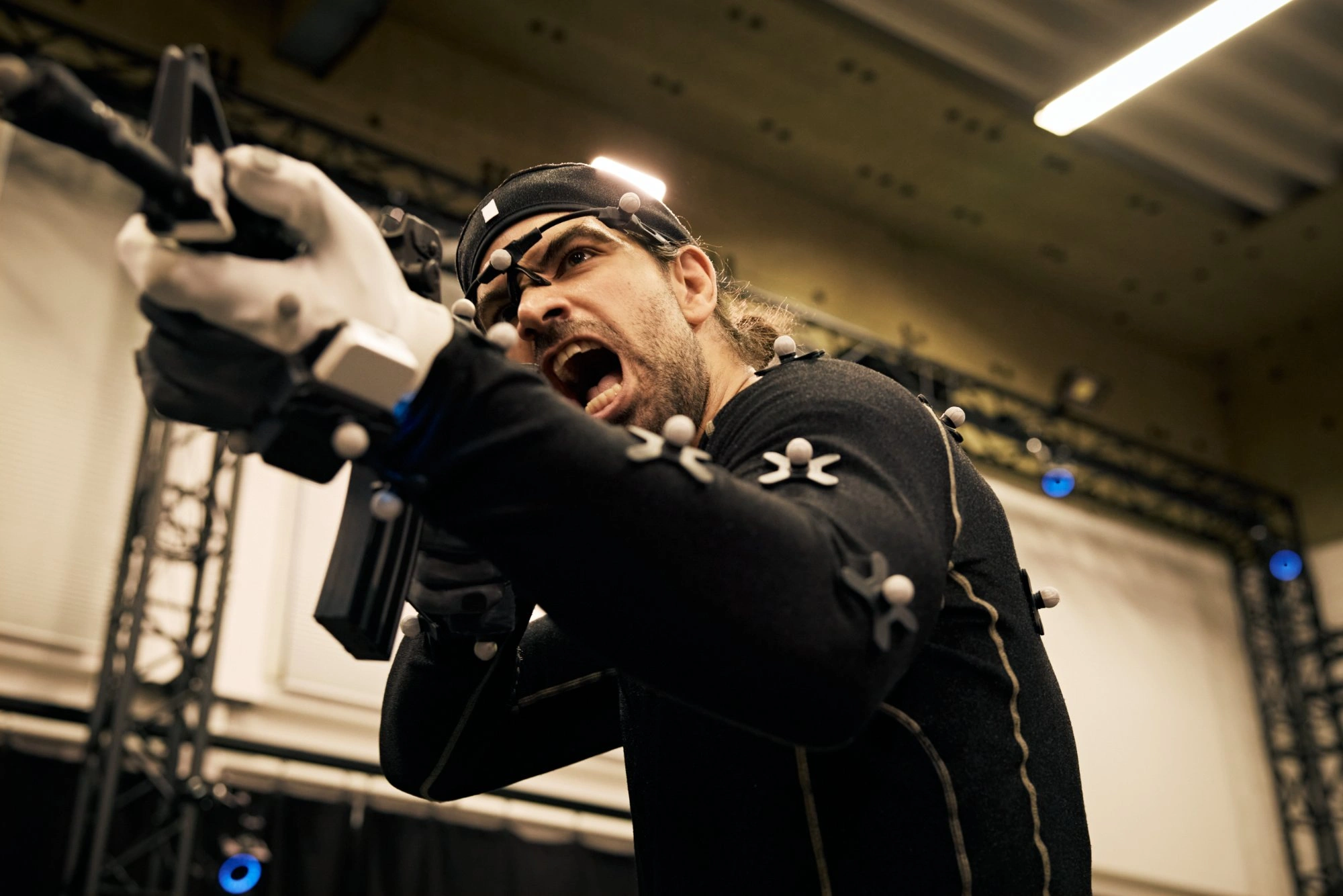 Motion capture performer with sword in studio