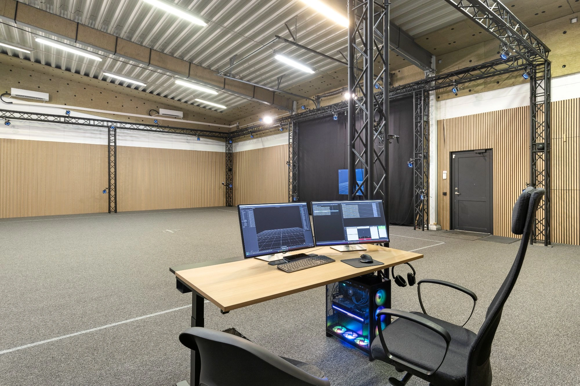 OptiTrack PrimeX 22 camera with people in background